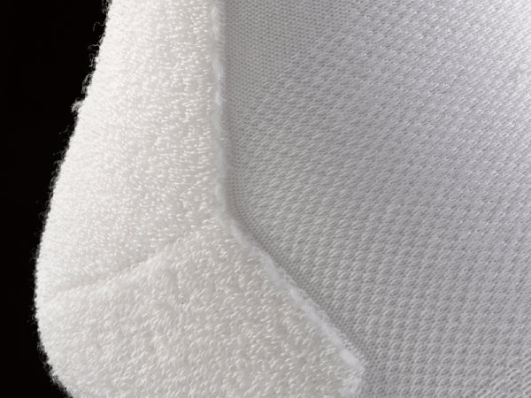 A white sock inside out to show the tiny loops of thread forming the cushion