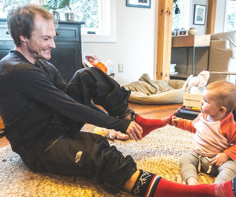 Jake Blauvelt at home wearing darn tough socks and playing with his kids