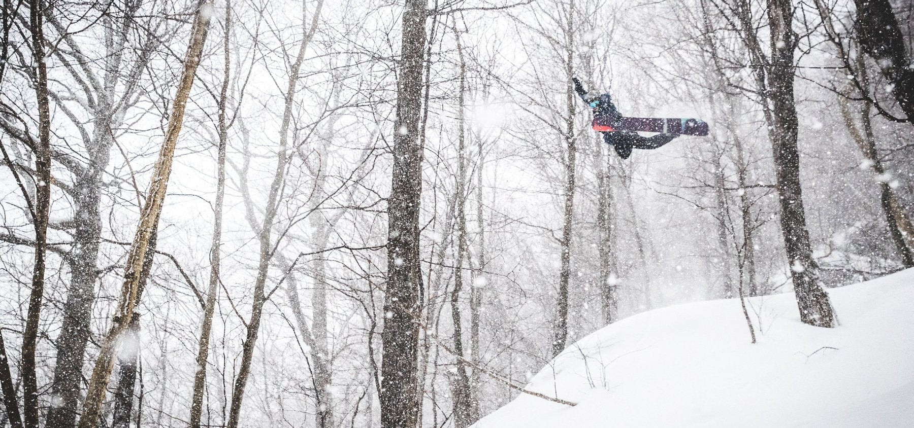 Pro snowboarder Jake Blauvelt getting some air while riding