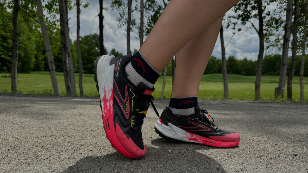 Kate's feet wearing her running shoes and the original Darn Tough running socks