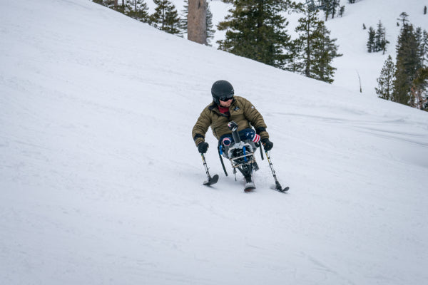 Adaptive skier on the slopes wearing darn tough merino wool ski socks