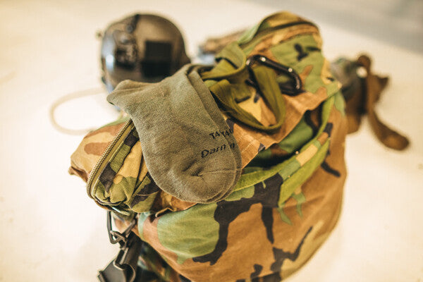 Darn tough tactical socks on a camo backpack
