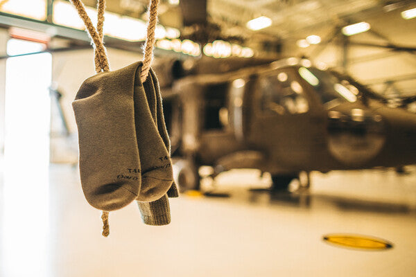 A pair of Air Force ocp socks hanging in front of a helicopter
