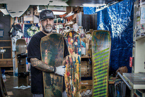 Max holding up a snowboard