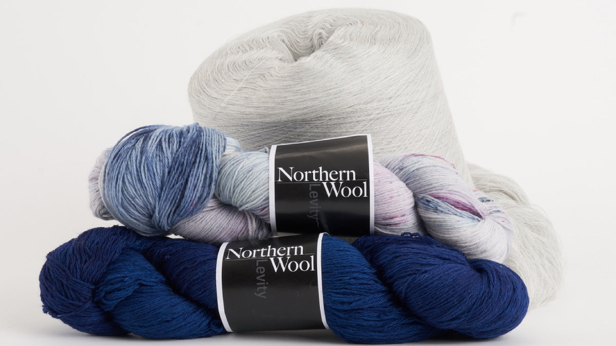 Northern Wool from Bobolinks next to a cone of Darn Tough merino wool yarn, used to make socks