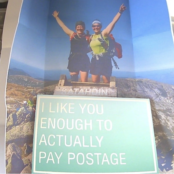 Picture of two hikers on summit with message "I like you enough to actually pay postage"