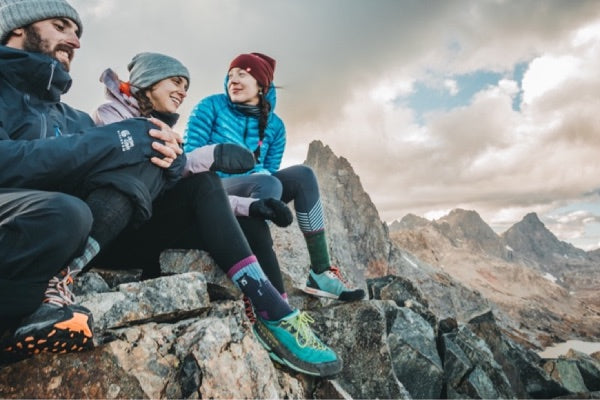 three hikers wearing merino wool socks in cold weather