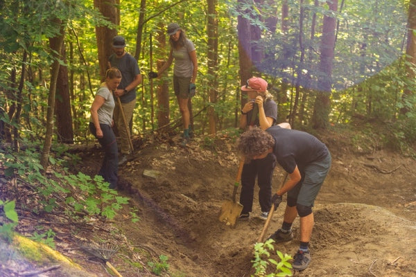 Volunteers digging up dirt for the trail work