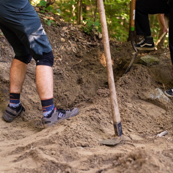 Close up of person grading the bike trail 