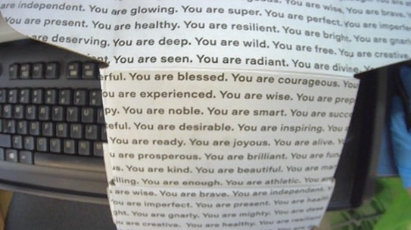 Packaging paper covered in positive affirmations like you are blessed, you are smart