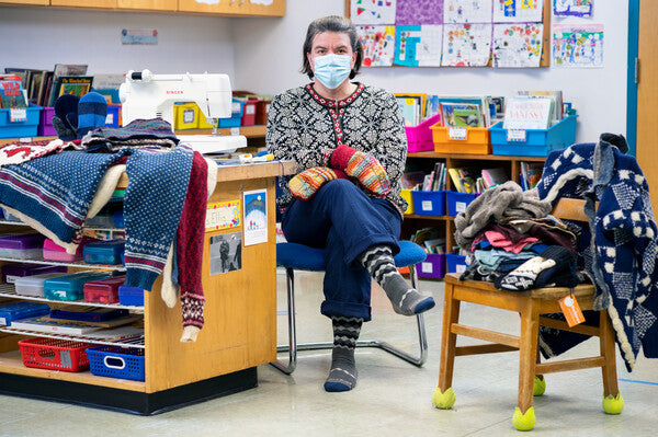 Jen wearing the jenerosity sock and mittens at her sewing table