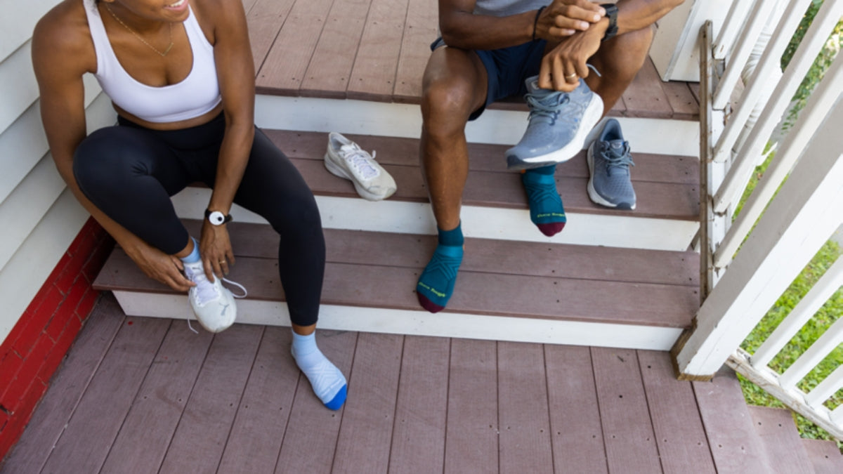 Two people getting ready for a run in Darn Tough running socks