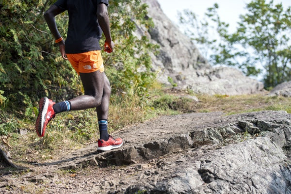 Trail runner on trail wearing merino wool running socks