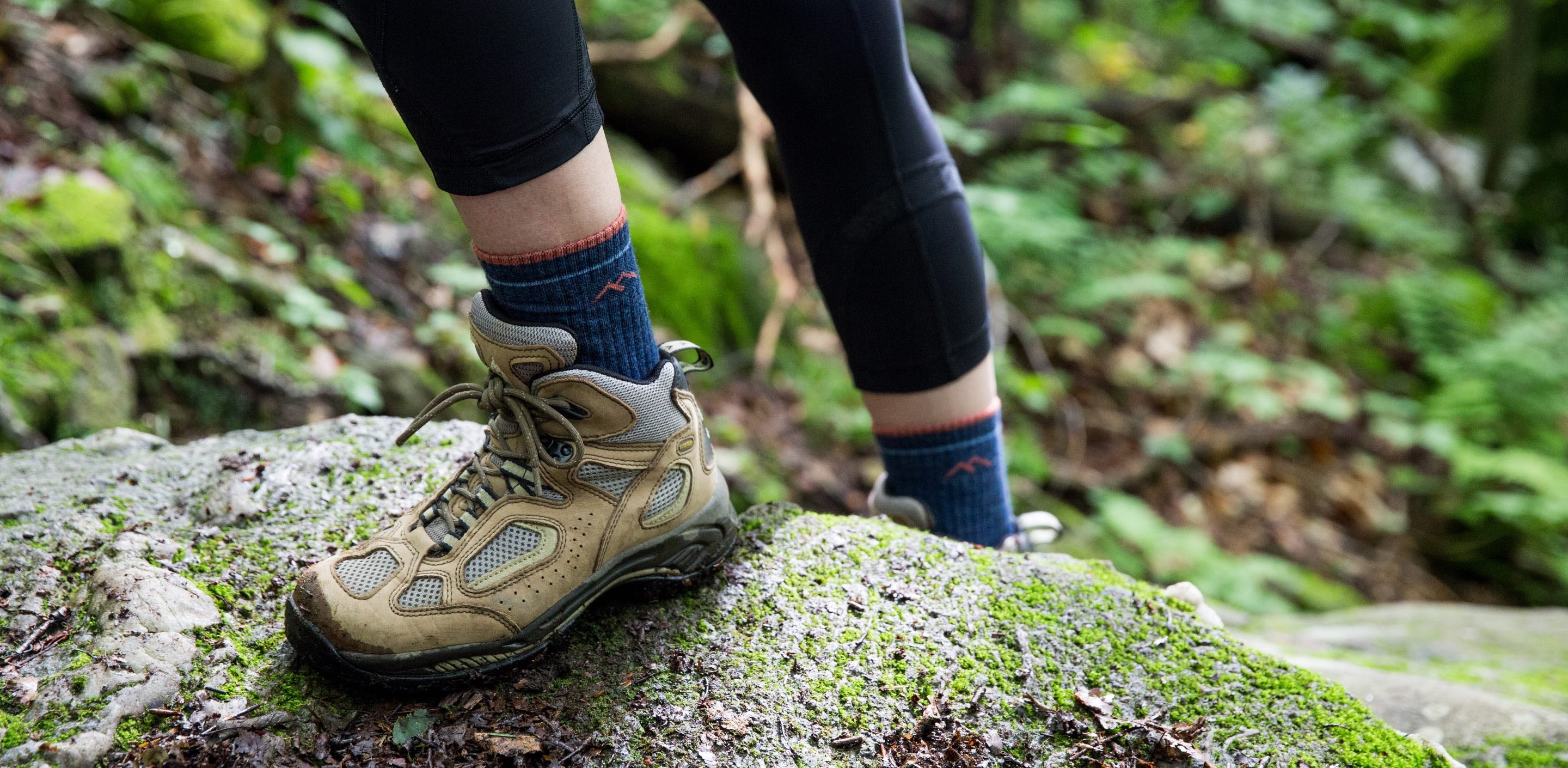 Woman wearing darn tough hiking socks made with merino wool, not cotton