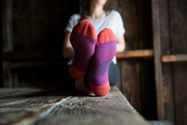 Hiker with feet up showing off her non-stinky, odor-resistant merino wool socks