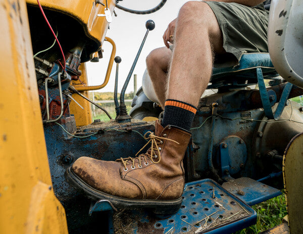 Farmer driving tractor wearing midweight work socks