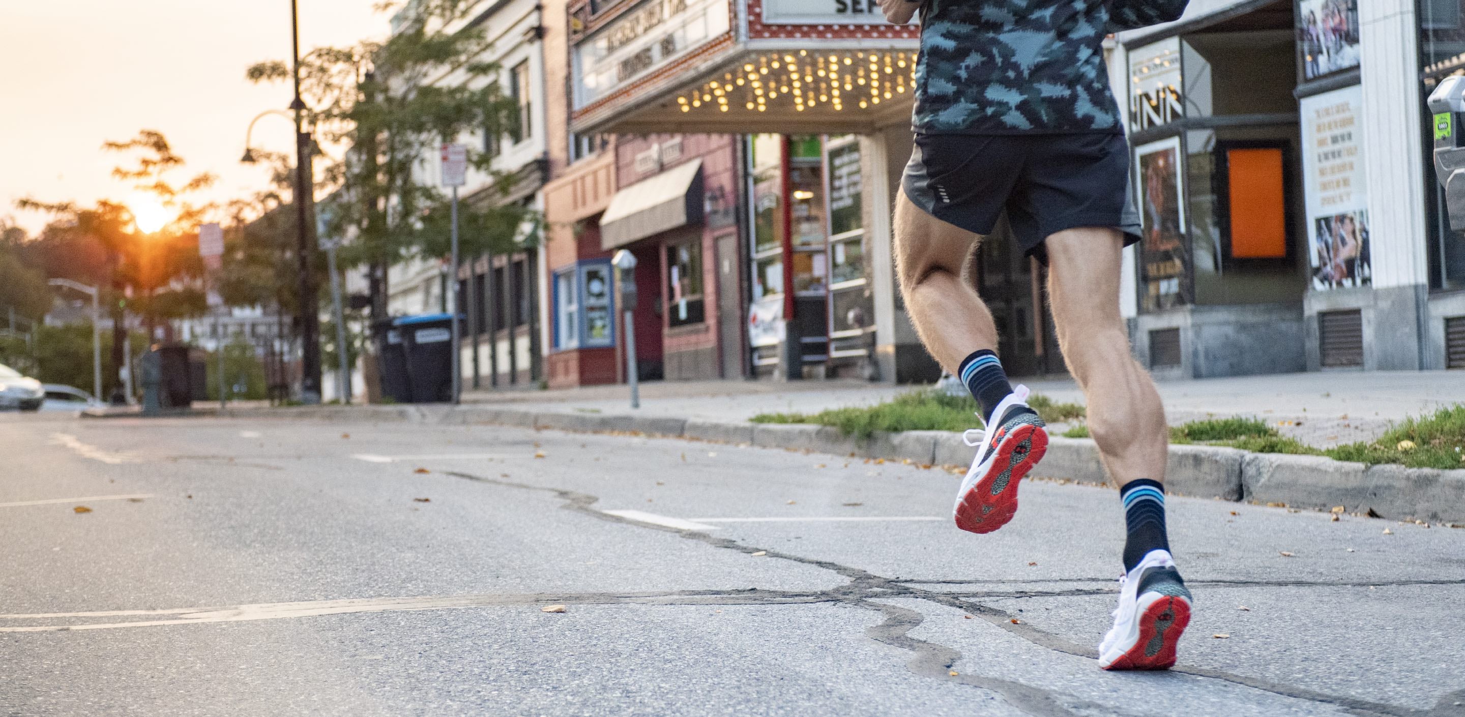 Josh Ferenc running down the road in darn tough running socks