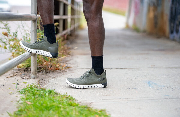 Person wearing our ultralight black running socks, which make durable liner socks