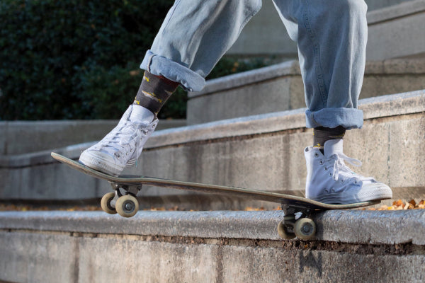 Skateboarder wearing the Spey Fly socks while doing tricks on stairs