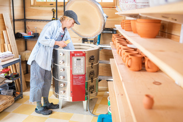 Potter wearing everyday socks with cushion while working in shop