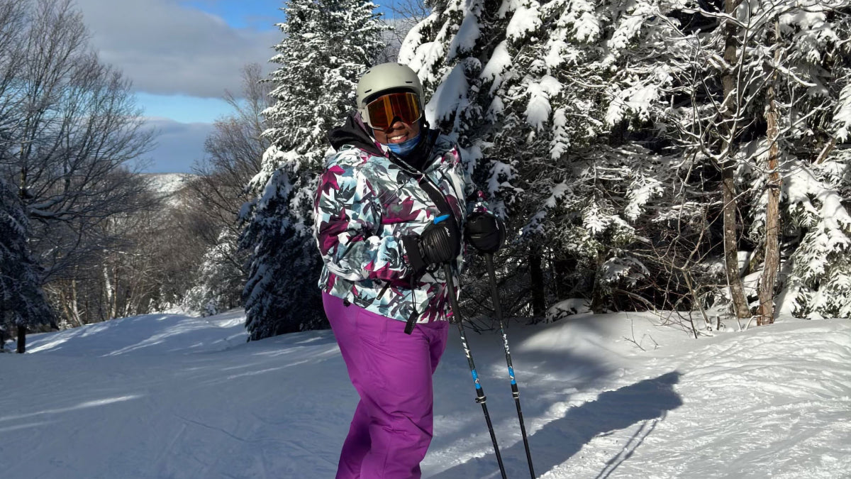 Mirna Valerio out on her skis smiling before she heads down the mountain