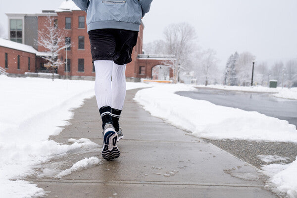 Closeup of person running while wearing the element micro crew socks in black