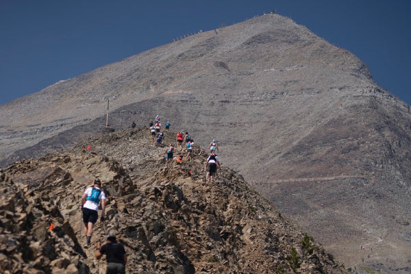 Rut Race runners headed towards the next peak over rocky terrain