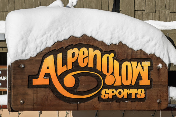 The Alpenglow Sports store sign, topped with a fresh layer of snow