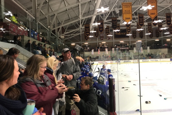 Another image of Norwich Hockey fans throwing socks on the ice