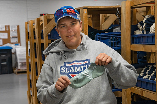 Jen holding up the Element No Show Tab socks, the perfect socks for summer days