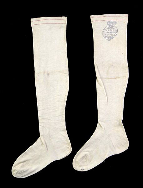 A pair of knee-high, very old white stockings