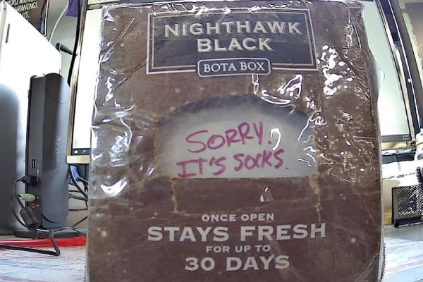 An Upcycled wine box advertising "stays fresh for 30 days" and a note that says "sorry, not socks"