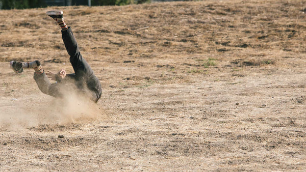 Skateboarder hitting the dirt hard after a big jump