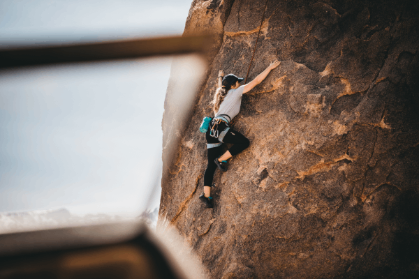 Rock climber scaling rock face