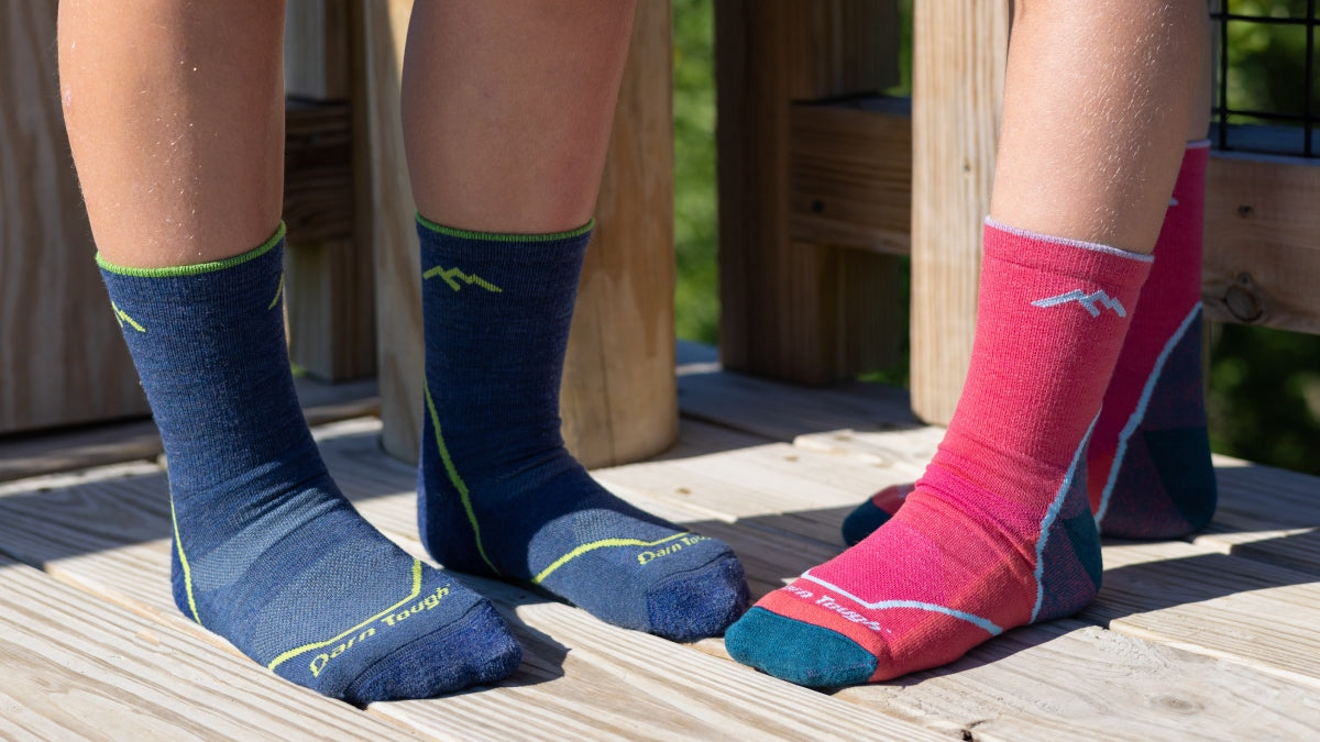 2 pairs of small feet in the kid's Micro Crew Hiking Socks