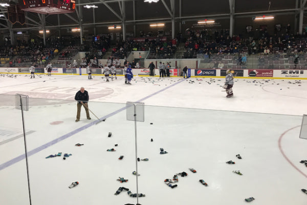 Darn Tough socks scattered all over the ice hockey rink