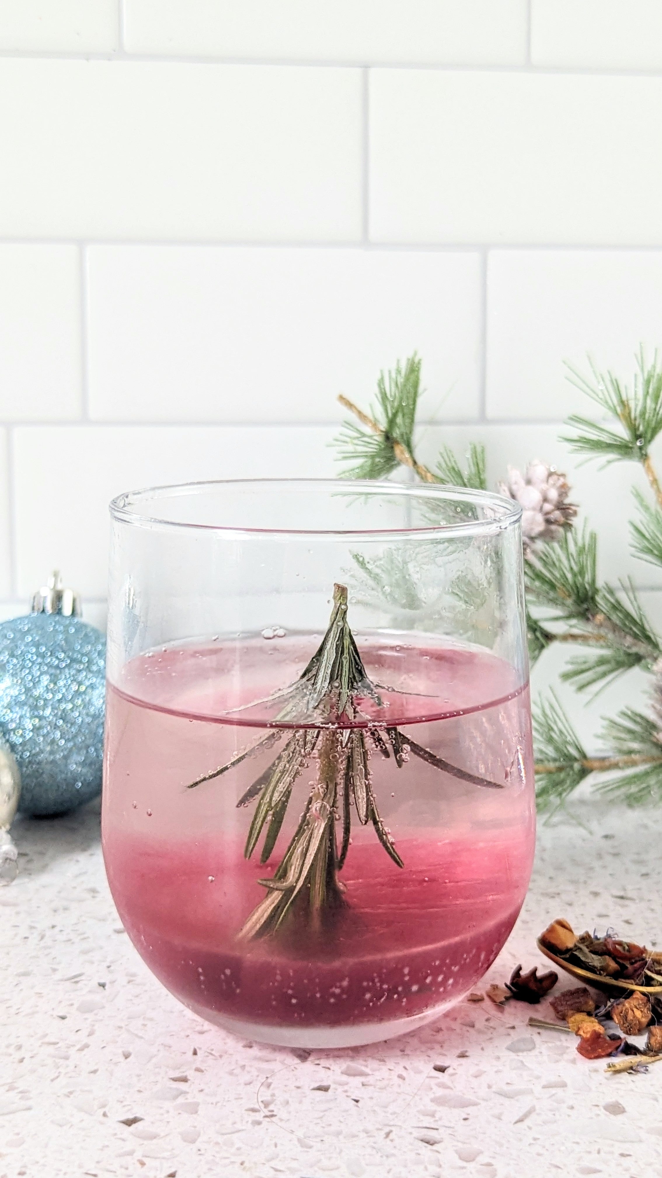 snow globe cocktail with rosemary christmas tree