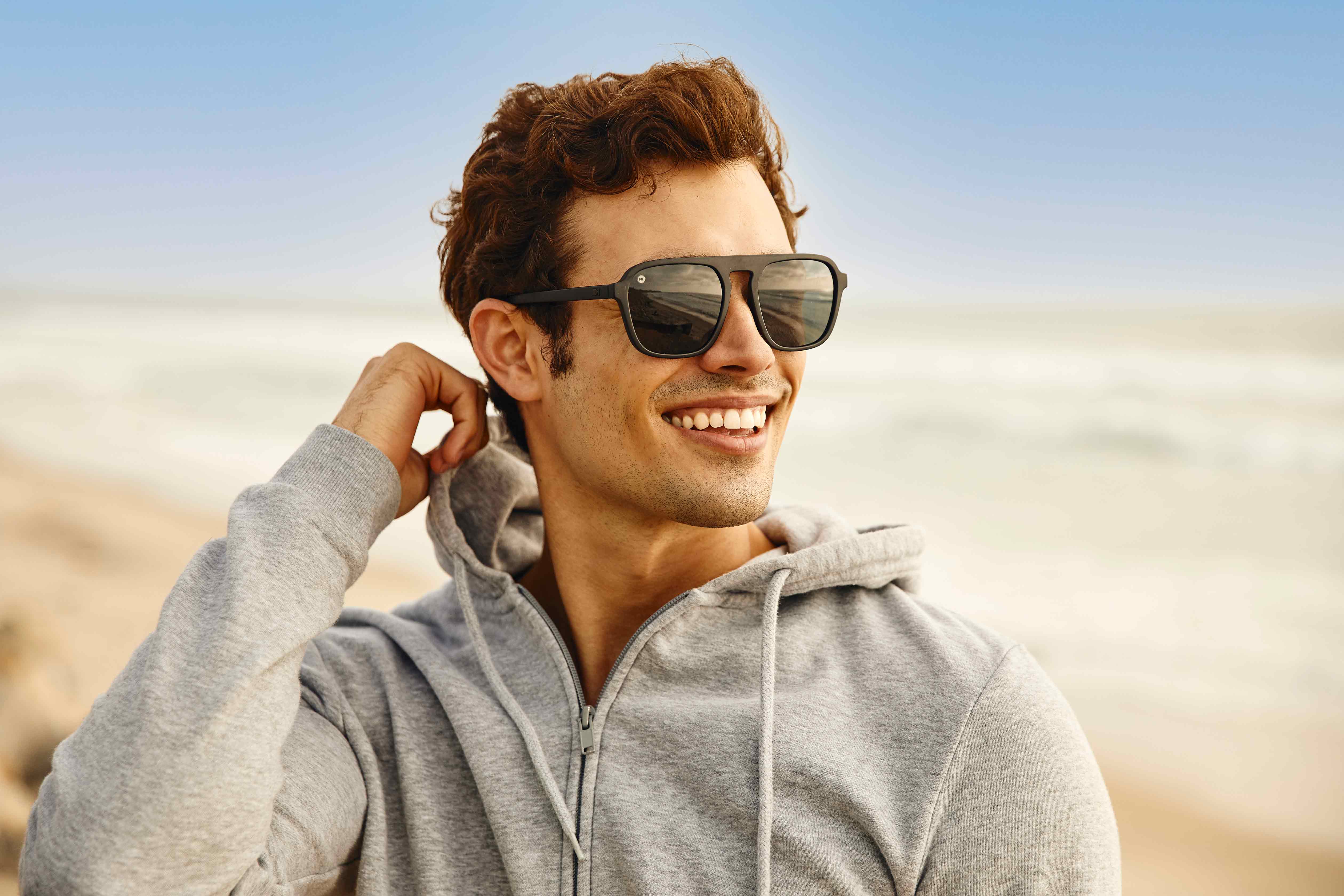 Guy on the beach wearing Pacific Palisades Sunglasses