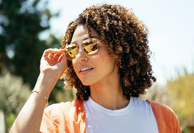 Woman wearing rose gold copper mile highs sunglasses