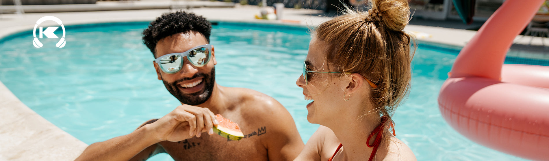 Couple eating watermelon by the pool wearing Knockaround sunglasses