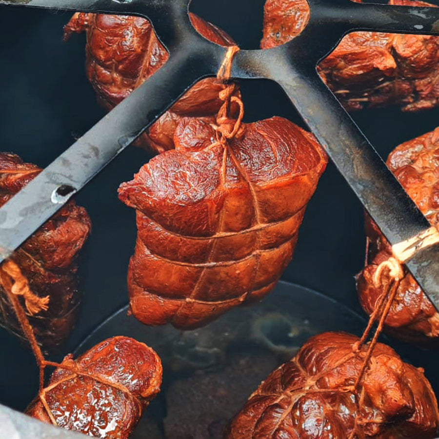Meat hanging within a meat smoker