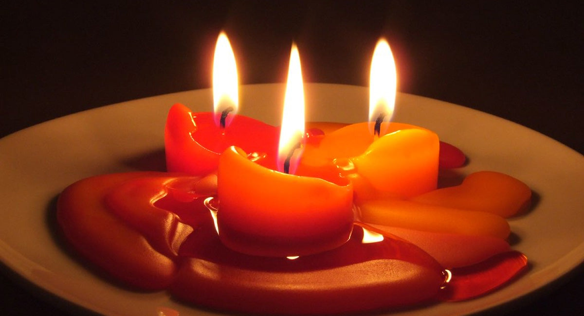 Red Candles Burning in a Dish