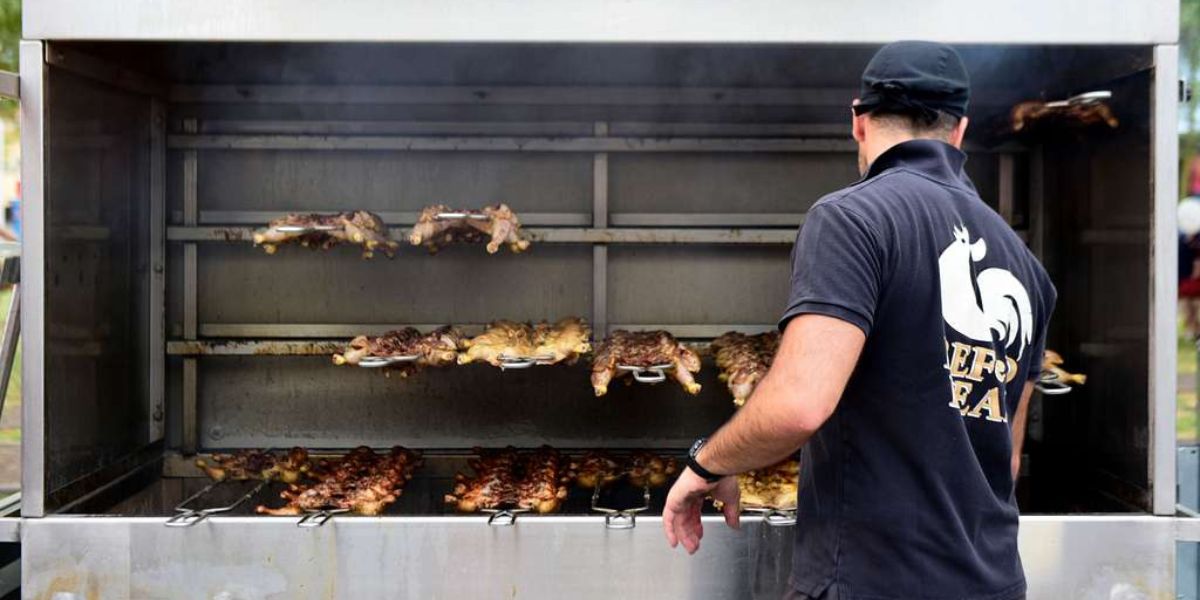 Man checking his meat within a mear smoker