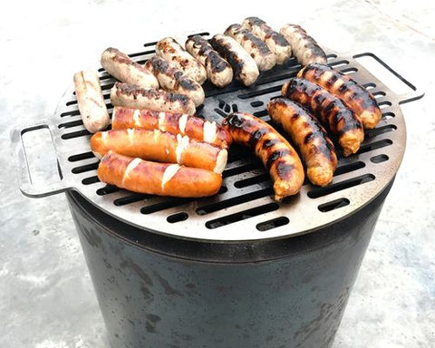Sausages cooking on a Volcann smoke free fire pit