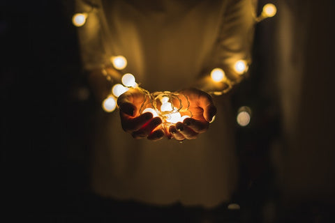 Child holding christmas lights