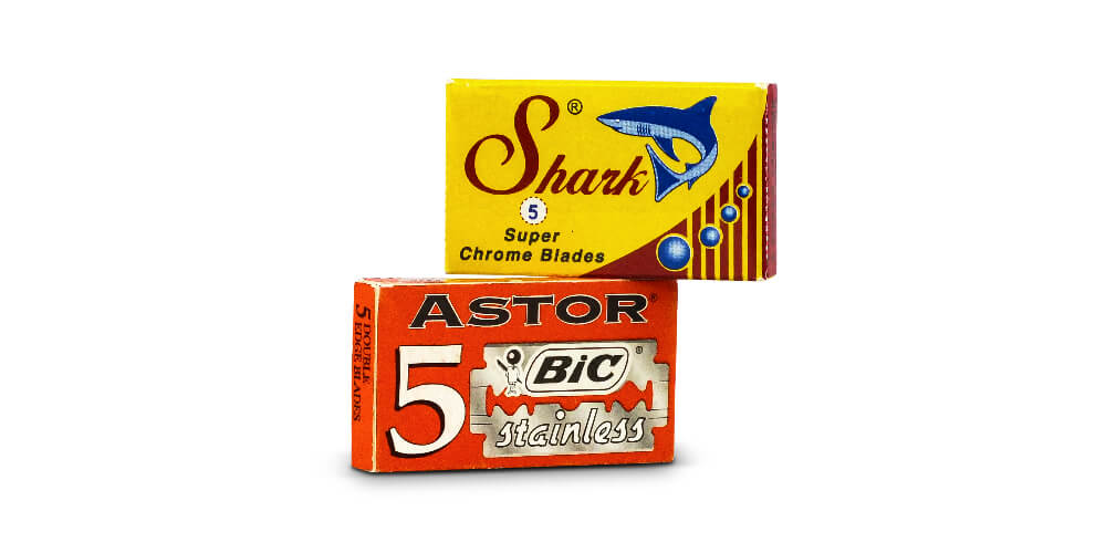 Astor BIC Stainless and Shark Super Chrome double-edge razor blade packs on white background