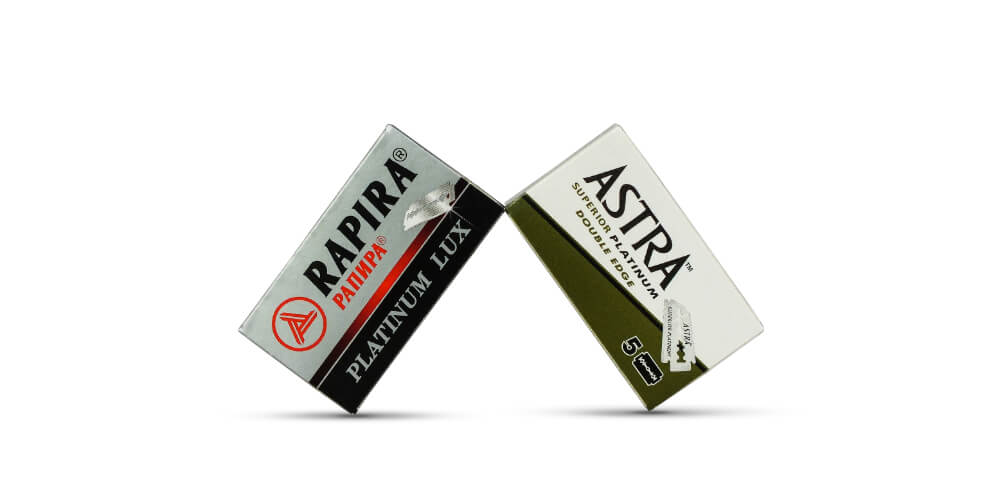 Astra Superior Platinum and Rapira Platinum Lux packs of double-edge razorblades on a white background