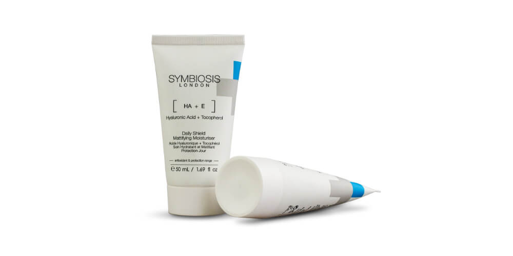 Two tubes of the Symbiosis London Mattifying Shield Moisturiser on a white background