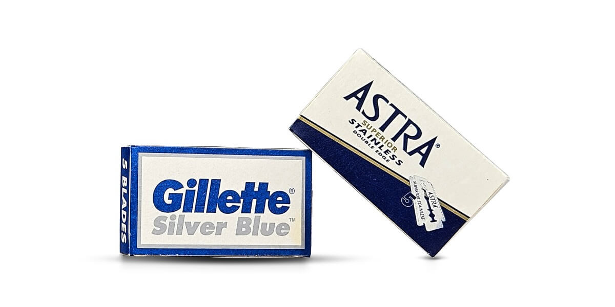 Gillette Silver Blue and Astra Blue Stainless Double-Edge (DE) razor blade packs on a white background