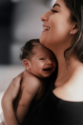 A happy mother holding her newborn baby